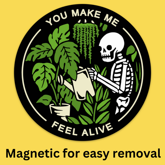 Bumper magnet featuring skeleton holding potted plants with text 'You Make Me Feel Alive' on black circular background