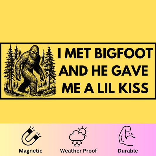 Bumper magnet featuring Bigfoot in forest with text 'I Met Bigfoot and He Gave Me a Lil Kiss' on yellow background.