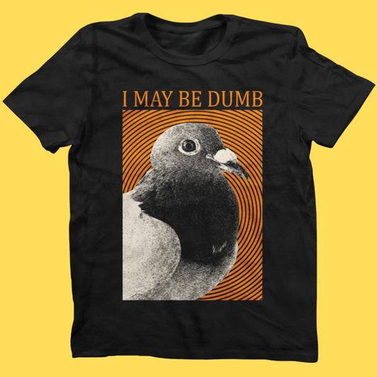 Black graphic tee featuring a pigeon with 'I May Be Dumb' text and orange striped background design on yellow backdrop.
