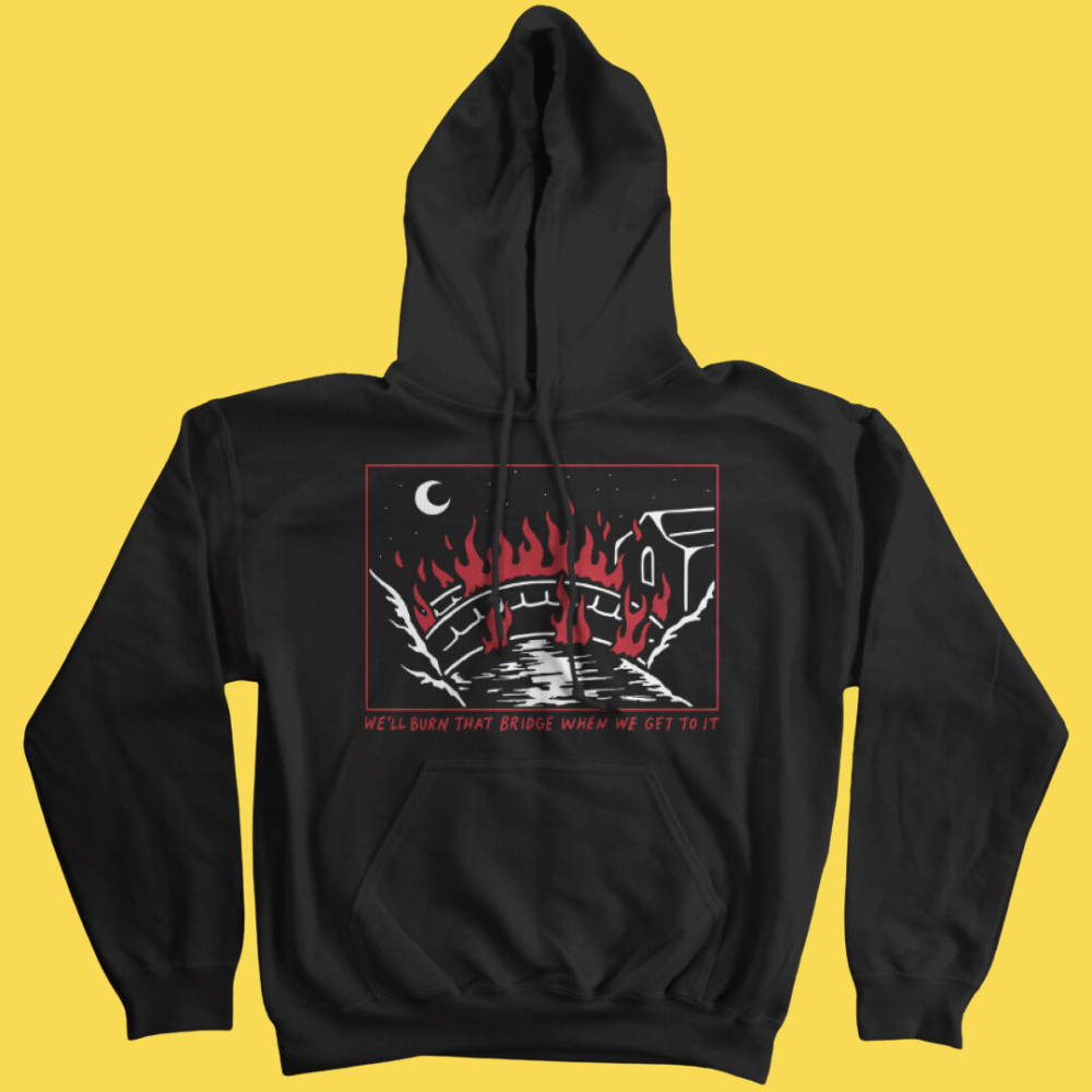 Black graphic hoodie with red and white illustration of a burning bridge under a crescent moon and text 'We'll Burn That