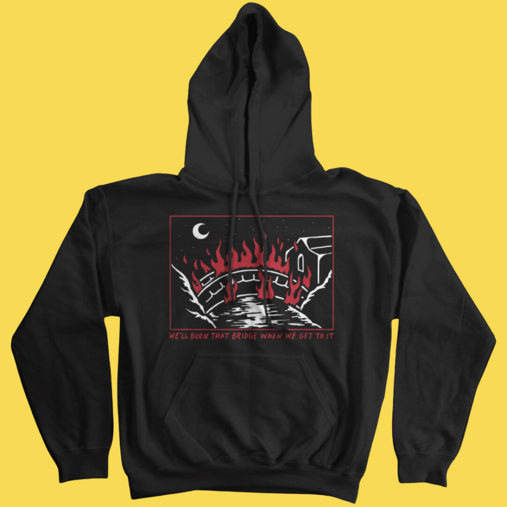Black graphic hoodie with red and white illustration of a burning bridge under a crescent moon and text 'We'll Burn That