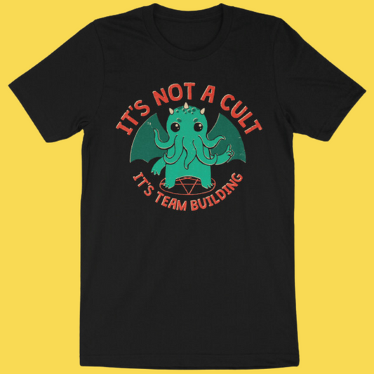 Black graphic tee featuring a cute green Cthulhu with 'It's Not a Cult It's Team Building' text on yellow background.