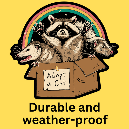 Vinyl sticker featuring a raccoon, opossum, and rat in a box with rainbow, text 'Adopt a Cat', yellow background.