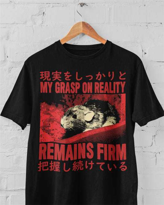 Black graphic tee with red rat illustration and text 'My Grasp On Reality Remains Firm' with Japanese characters on yellow