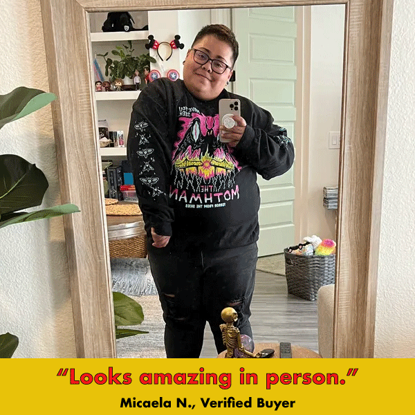 Black graphic sweatshirt with colorful 'Mothman' design and sleeve details, worn by person taking mirror selfie