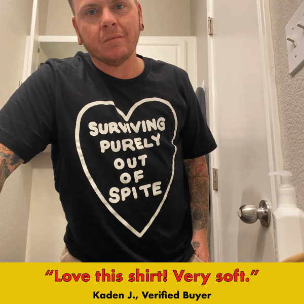 Black graphic tee with white heart design featuring text 'Surviving Purely Out Of Spite'