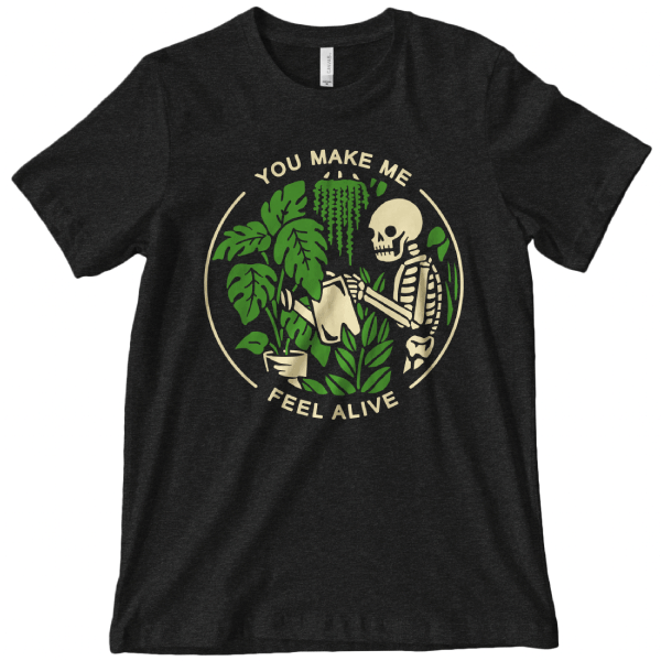 Black graphic t-shirt with a skeleton with a watering can surrounded by plants with text that reads you make me feel alive